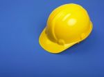 Yellow Hard hat On Blue Stock Photo