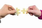 Two Hands Uniting Fitting Puzzle Pieces Stock Photo