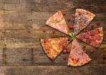 Diferents Types Of Pizza Cut On Wooden Table Stock Photo