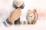 Double Exposure Of Businessman With A Row Of Stack Money Coins Stock Photo