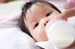 Pretty Baby Girl Is Drinking Milk Stock Photo