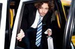 Corporate Guy Getting Out Of A Taxi Cab Stock Photo