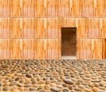 Wooden Wall With Door And Stone Floor In Front Off Stock Photo