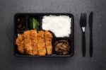 Japanese Food Tonkatsu Rice And Vegetable Take Away On Table Background Stock Photo