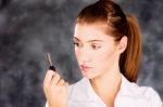 Brunette Looking At A Key Stock Photo