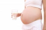 Fresh Water Drinking Of Pregnant Woman On White Background Stock Photo