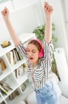 Beautiful Young Woman Listening To Music At Home Stock Photo