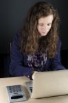 Teen Sitting At Table With A Laptop Stock Photo