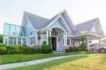 Bright Blue House In Sunlght With Colorful Poppies And Some Grac Stock Photo