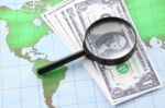 Magnifying Glass Black Frame And Currency On World Map Paper Stock Photo