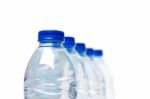 Row Of Plastic Water Bottles Isolated On A White Background Stock Photo