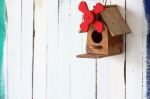 Colorful Bird House On Grunge Wall Stock Photo