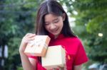 Portrait Of Thai Teen Beautiful Girl In Chinese Dress, Happy New Year And Open Box Gift, Smile And Very Happy Stock Photo