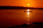 Fisherman On Boat At Sunset Stock Photo