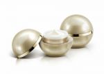 Two Golden Sphere Cosmetic Jar On White Background Stock Photo