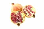 Pomegranate And Two Half On White Background Stock Photo