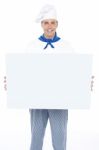 Handsome Male Chef Holding Ad Board Stock Photo