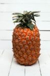 Fresh Azores Pineapple Fruit Isolated On A White Wooden Background Stock Photo