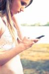 Girl With Smart Phone Near Beach Stock Photo