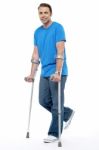 Young Man With Crutches Trying To Walk Stock Photo