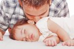 Father Kissing His Baby Sleeping Stock Photo