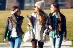 Three Students Girls Walking In The Campus Of University Stock Photo