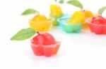 Red Deletable Imitation Fruits In Jelly Cup On White Floor Stock Photo