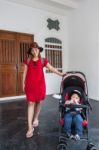 Mother And Son Standing At The House Stock Photo