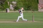 Playing Cricket On The Green At Bamburgh Stock Photo