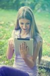 Beautiful Woman With Tablet Computer In Park Stock Photo