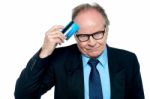 Businessman Scratching His Forehead With Plastic Card Stock Photo