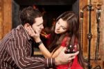 Woman Caress Her Man Near Fireplace Stock Photo