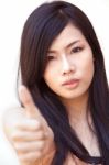 Asian Girl With Thumbs Up Gesture Stock Photo