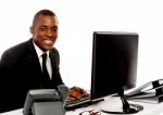 Smiling Businessman Using Computer Stock Photo