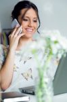 Pretty Young Woman Using Her Mobile Phone In The Office Stock Photo