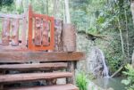 Small Waterfall Flowing Into A Calm Pool Of Water Stock Photo