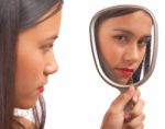 Unhappy Girl Looking At Mirror Stock Photo