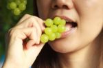 Woman Eating Green Grapes Friut Stock Photo