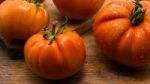 Freshly Picked Tomatoes, Place On Wooden Chopping Board And Table Stock Photo