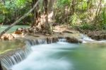 The Water Flowing Over Rocks And Trees Down A Waterfall At Huay Mae Khamin Waterfall National Park ,kanchana Buri In Thailand Stock Photo