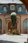 View Of A Statue Three People Holding A Sphere In A Courtyard In Stock Photo