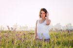 Model Sitting In Field Stock Photo