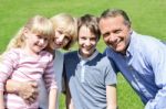 Lovable Family Enjoying Sunny Day Outdoors Stock Photo