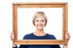 Middle Aged Lady Holding Photo Frame Stock Photo