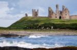 View Of Dunstanburgh Castle At Craster Northumberland Stock Photo