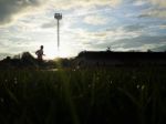 Silhouette  Running On Road At Sunrise Stock Photo