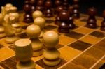 Light And Dark Wooden Chess Pieces On Chess Table Stock Photo