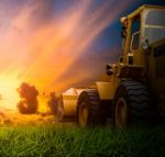 Yellow Tractor In A Field Stock Photo