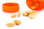 Closeup Of Orange Pills And Pill Bottle Stock Photo