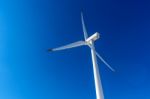 Wind Turbine And Blue Sky In Winter Landscape Stock Photo